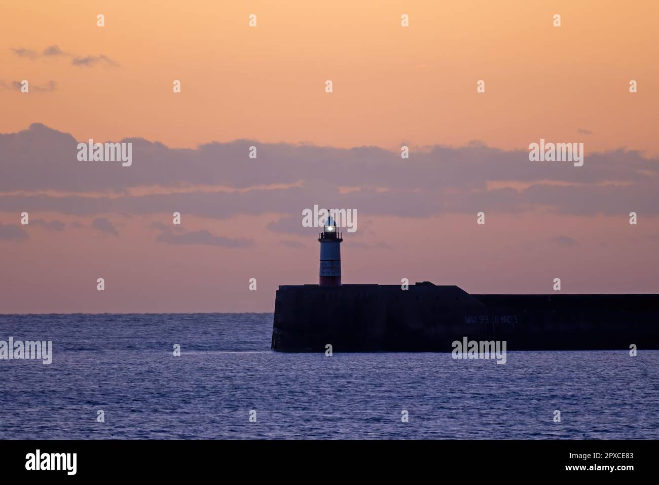 Newhaven Lighthouse in Sussex, at sunset during January 2022. Stock Photo