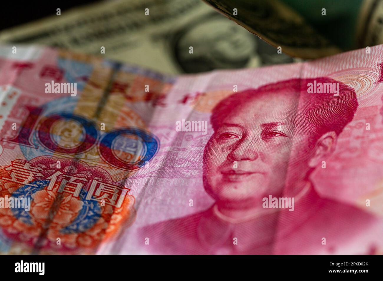 Berlin, Germany. 27th Apr, 2023. A Chinese 100 yuan banknote (front), and a 1 US dollar bill lie on a table. Credit: Fernando Gutierrez-Juarez/dpa/Alamy Live News Stock Photo