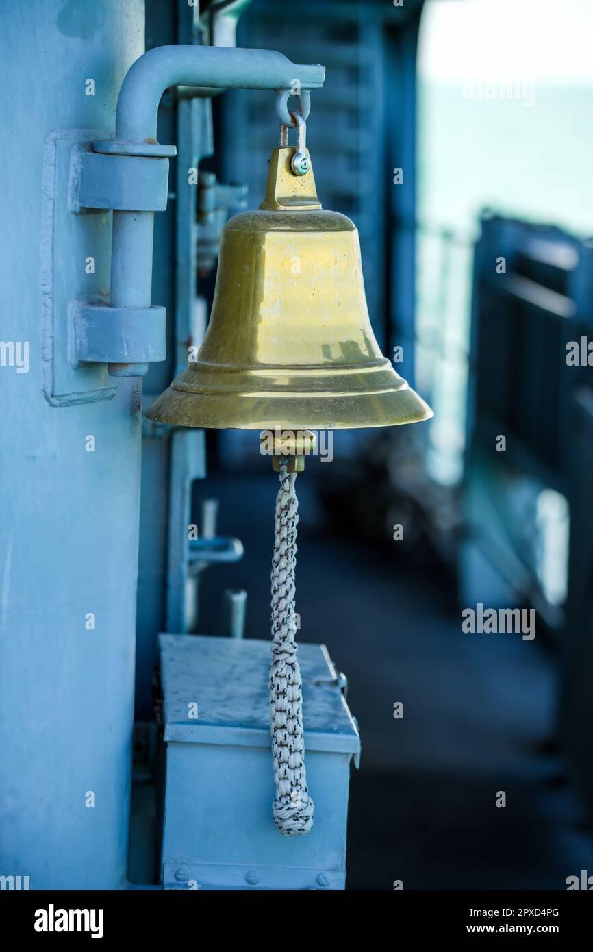 Antique brass ship's bell on a metal wall Stock Photo Alamy