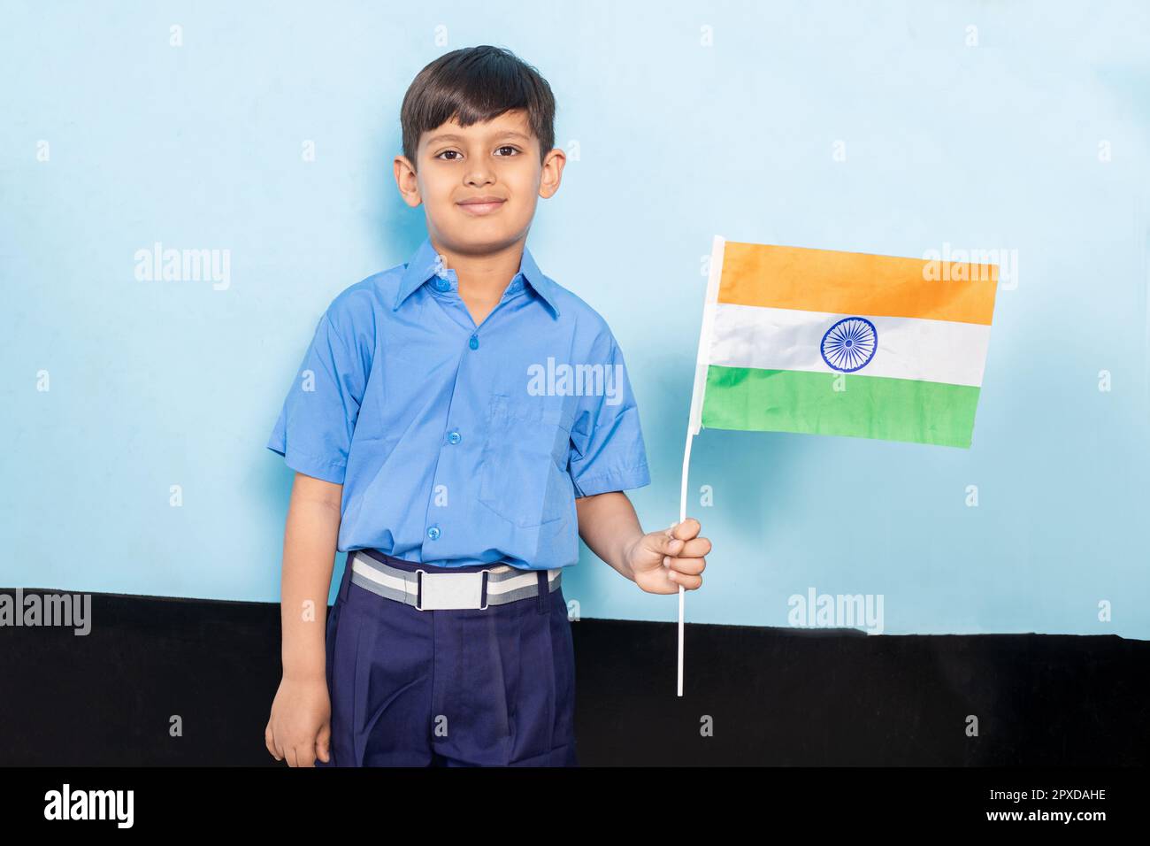 Happy Boy Kid Wearing School Uniform Holding Indian Flag In Hand 