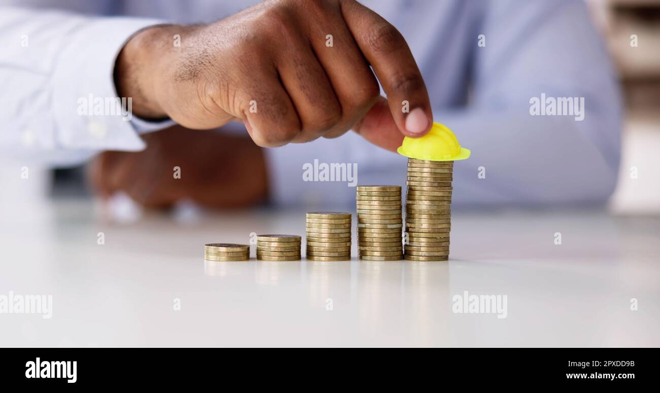 Construction Insurance And Budget Inflation. Coin And Hard Hat Stock ...