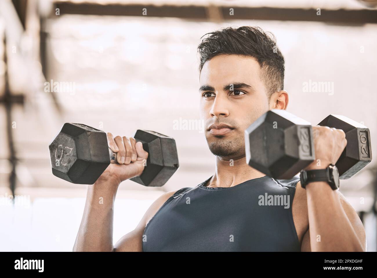 Serious bodybuilder lifting heavy weights in the gym. Working on those