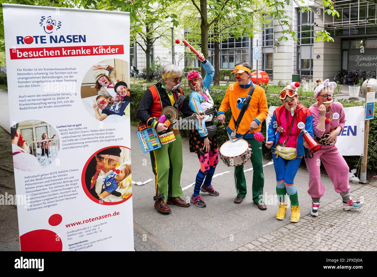 Berlin, Germany. 02nd May, 2023. The Red Noses Clowns Mopitz (l-r), Perdita Poppers, Bartusch, Natascha and Polli make music at the start of the nationwide clown relay through clinics and care facilities on the Charité grounds. The association Rote Nasen Deutschland e.V. has been bringing laughter and joie de vivre to people in need for 20 years with specially trained artists. Credit: Hannes Albert/dpa/Alamy Live News Stock Photo
