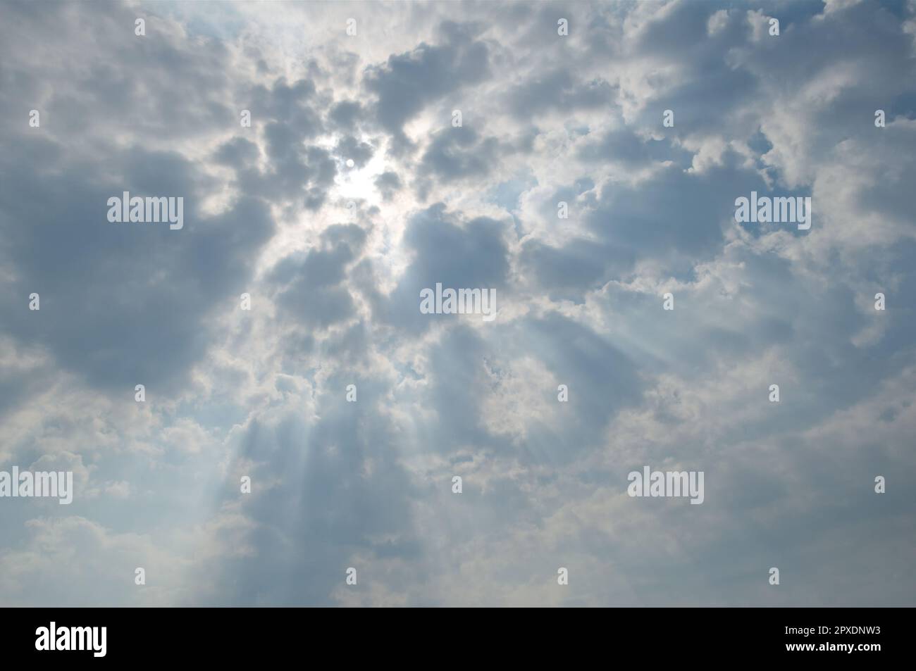 The Sun shines through clouds, Background Stock Photo Alamy