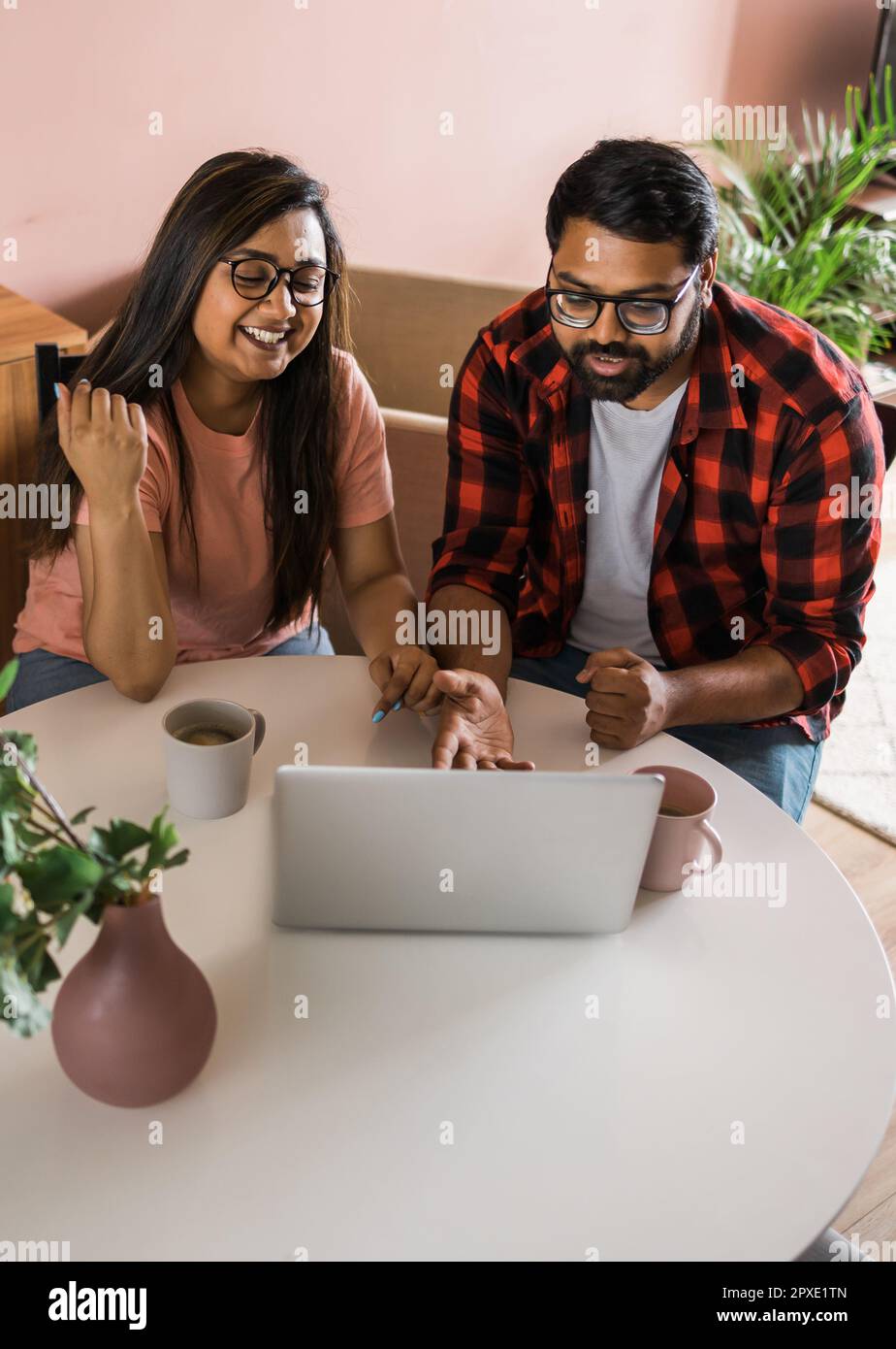 Happy family couple cuddle at desk make video call to friends