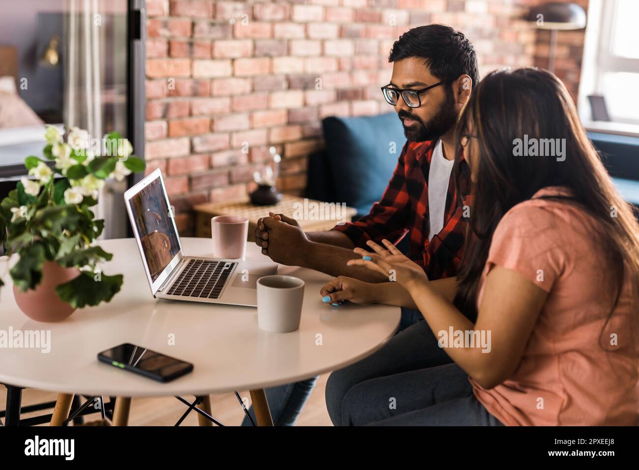 Happy family couple cuddle at desk make video call to friends using ...