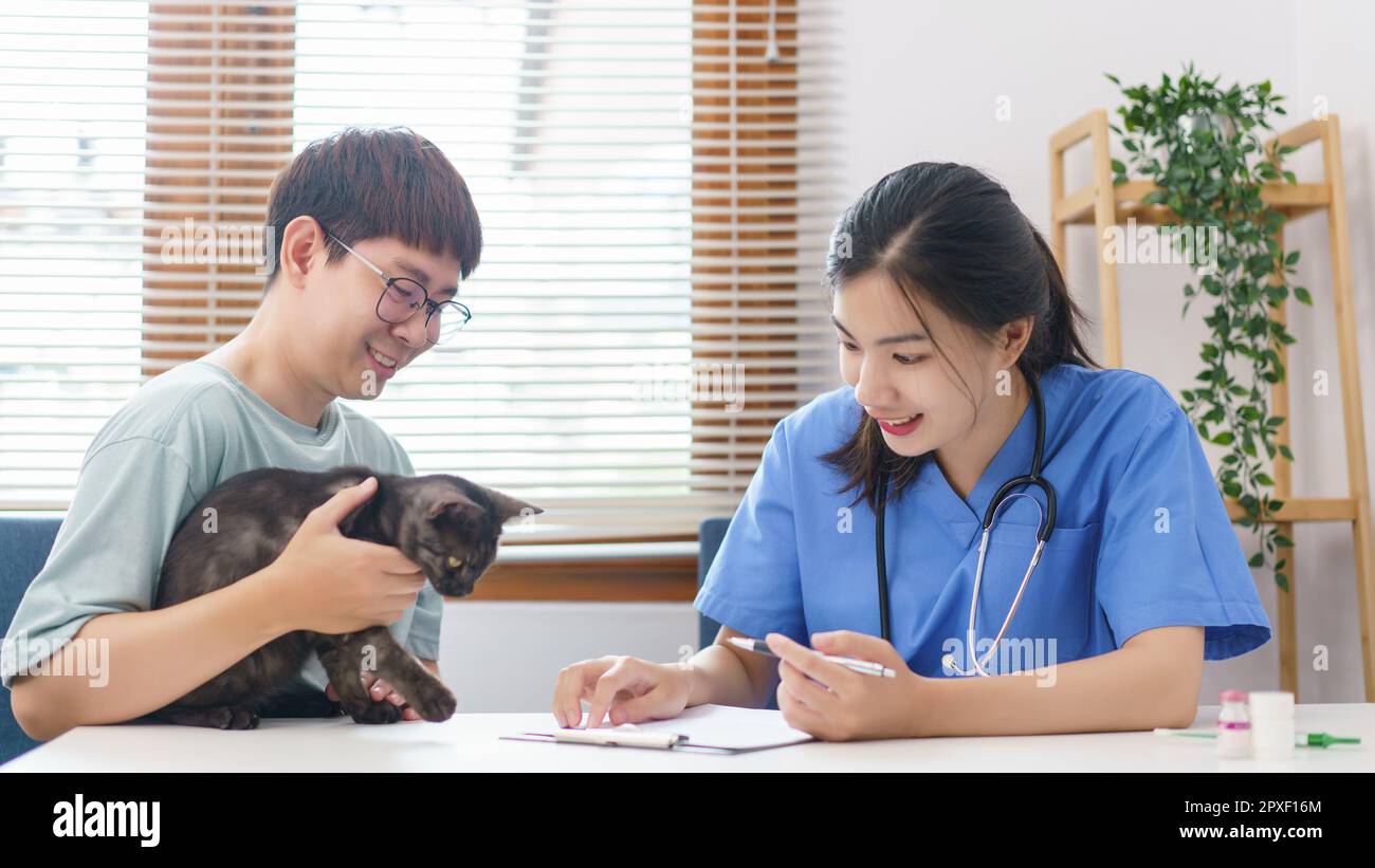 Pet care concept, Female veterinary examining the cat and writing