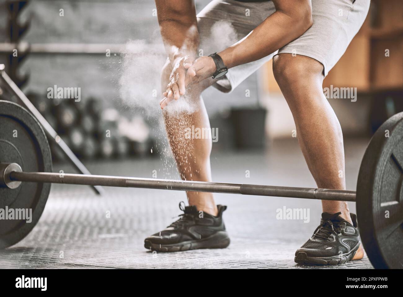 Hands of bodybuilder dusting before lifting weights. Fit athlete using