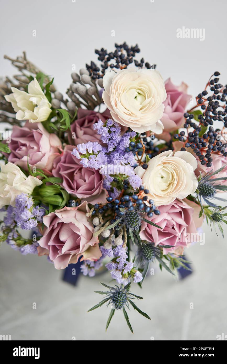 Beautiful bouquet of mixed flowers with ranunculus clooney hanoi in woman hand. Floral shop concept . Beautiful fresh cut bouquet. Flowers delivery Stock Photo