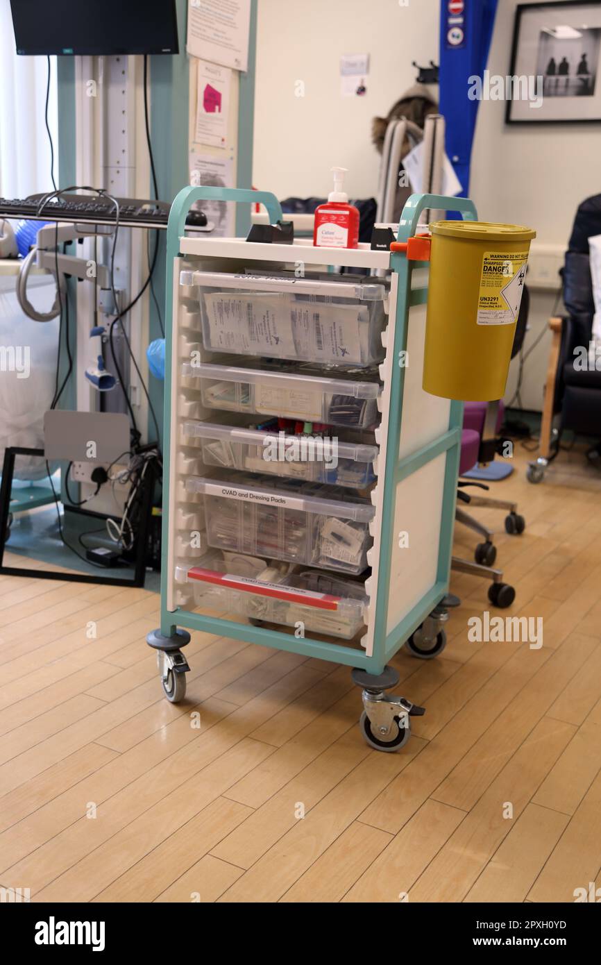 Dressing trolley with surgical dressing sets,phlebotomy tubes and CVAD and dressing Packs and clinical waste sharps bin Stock Photo