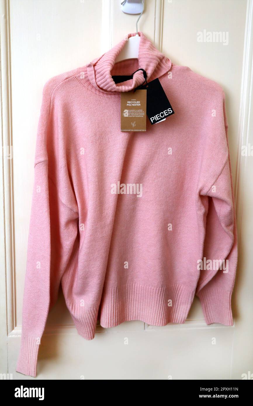 Recycled Polyester Pink Turtle Neck Jumper with Labels Stock Photo