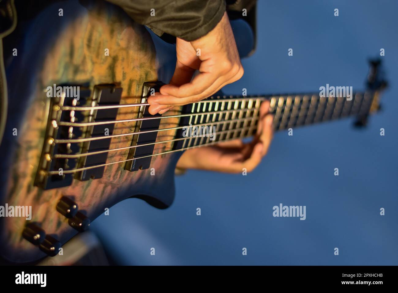 A young man strumming an electric guitar Stock Photo Alamy
