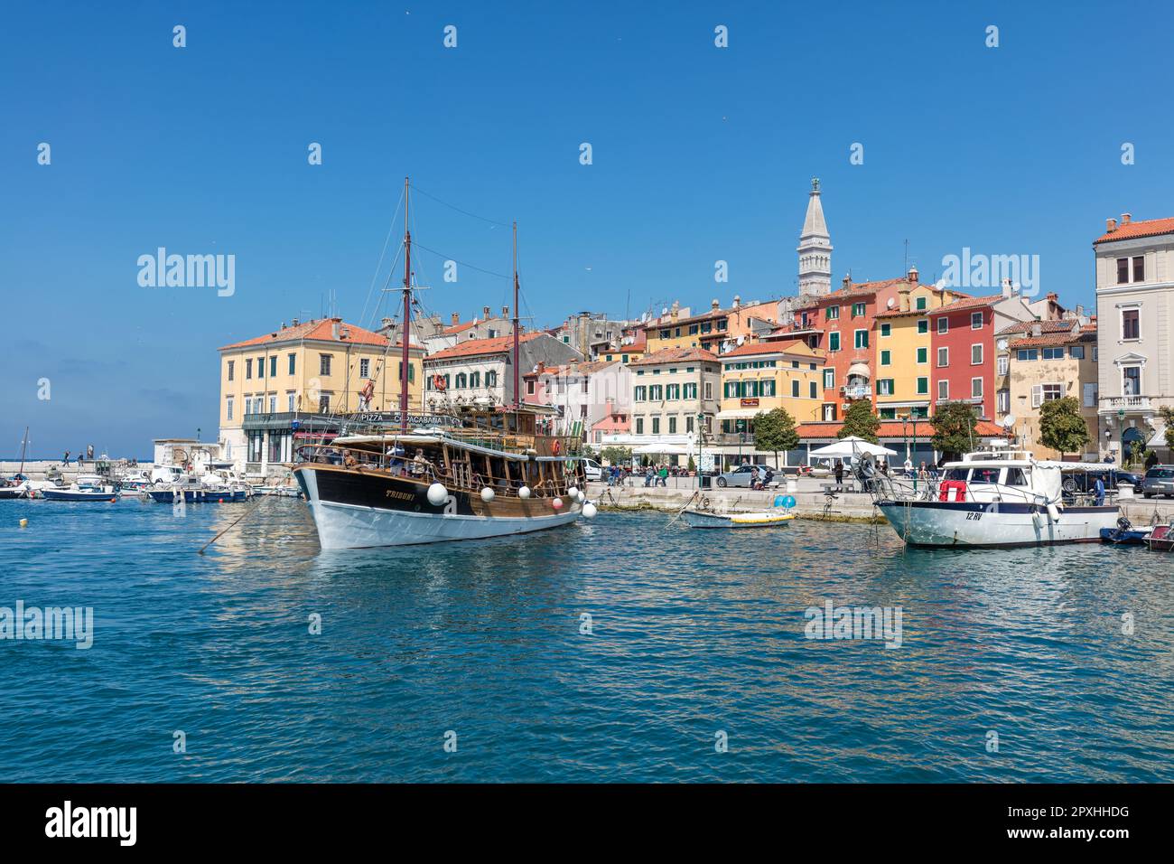 Boats moored in medieval Old Town harbour and marina in Adriatic Sea fishing port with historic  houses, shops, cafes, bars on Obala Pina Budicina Stock Photo