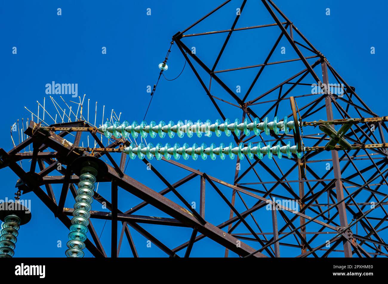 Line insulator on the electrical wires of a high-voltage tower. Electric wires. High-voltage power transmission tower. Electrical line insulators. Ene Stock Photo