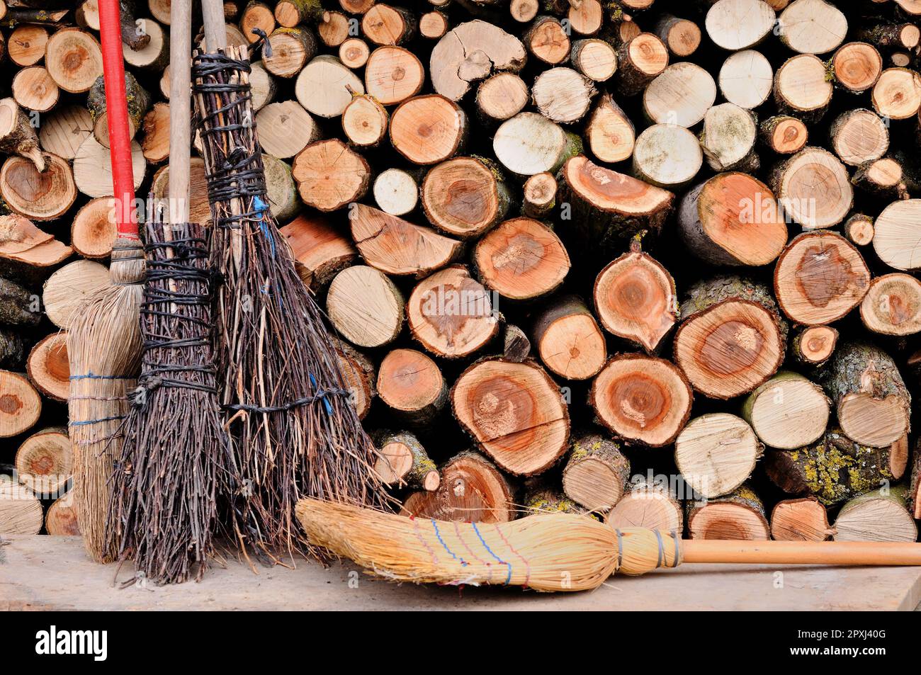 Broom Stack An image of a traditional broom leaning against a stack of freshly cut ...