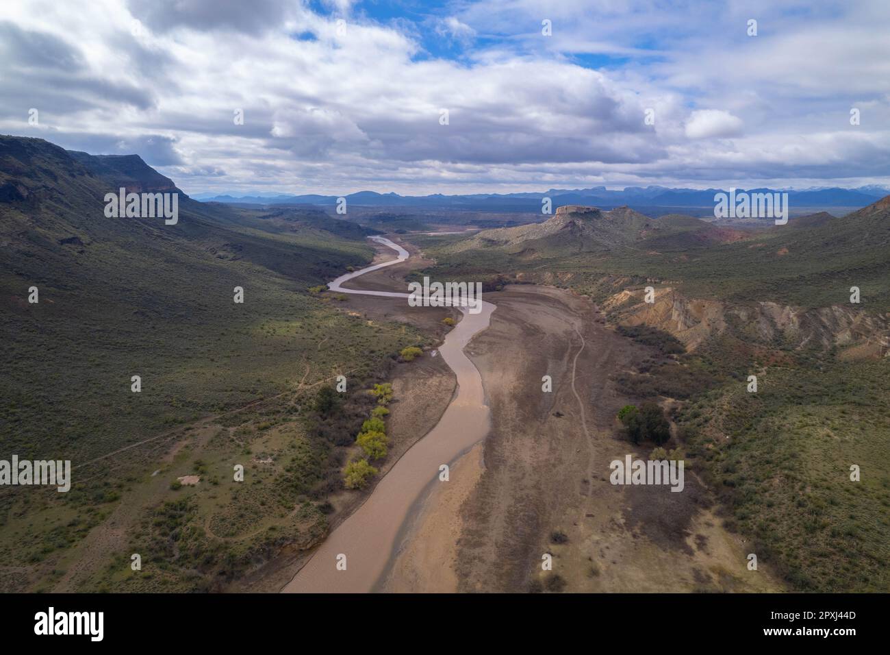 Agua Fria River flowing after a winter  storm with lake pleasant in the background Stock Photo