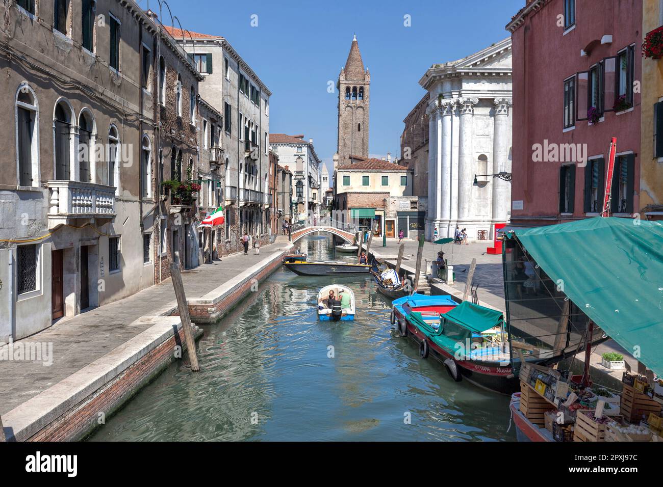 Boats on Rio de San Barnaba canal with Fondamenta Alberti (left) and San Barnabas bridge with Church of St Barnabas bell tower, Dorsoduro, Venice Stock Photo