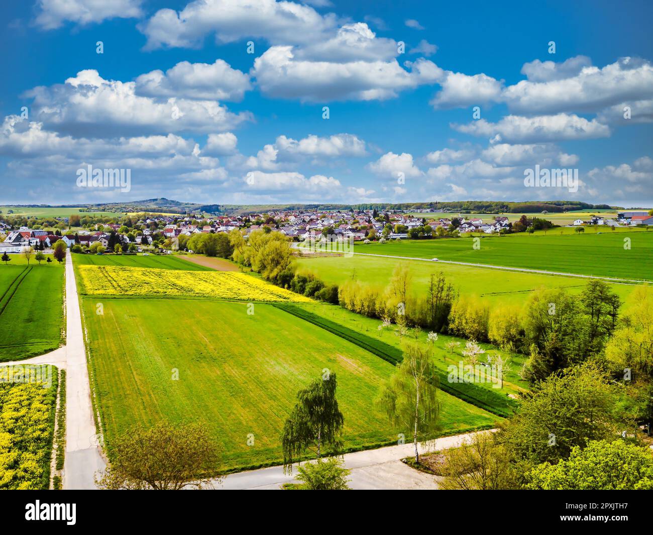 Drone shot from german landscape and small village with meadows in Hesse. Stock Photo