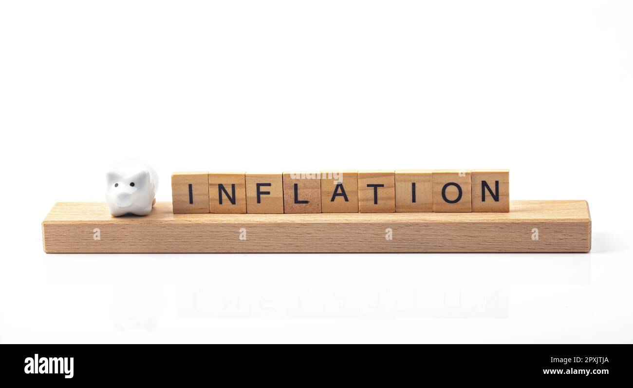 Inflation concept with letters and little piggy bank isolated ober white background Stock Photo