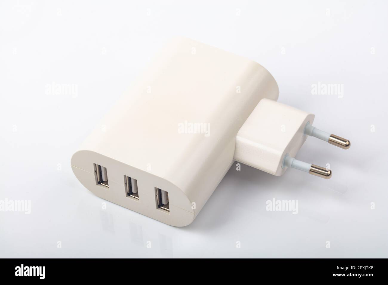White USB Power Socket with three usb charging connectors over bright background Stock Photo