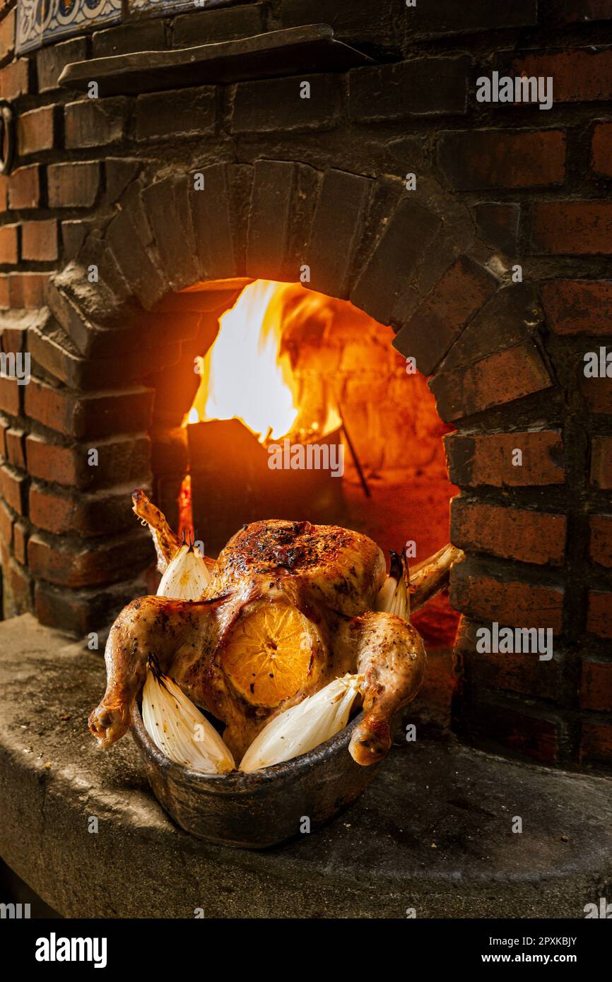 Wood-fired oven roasted chicken with citrus. Stock Photo