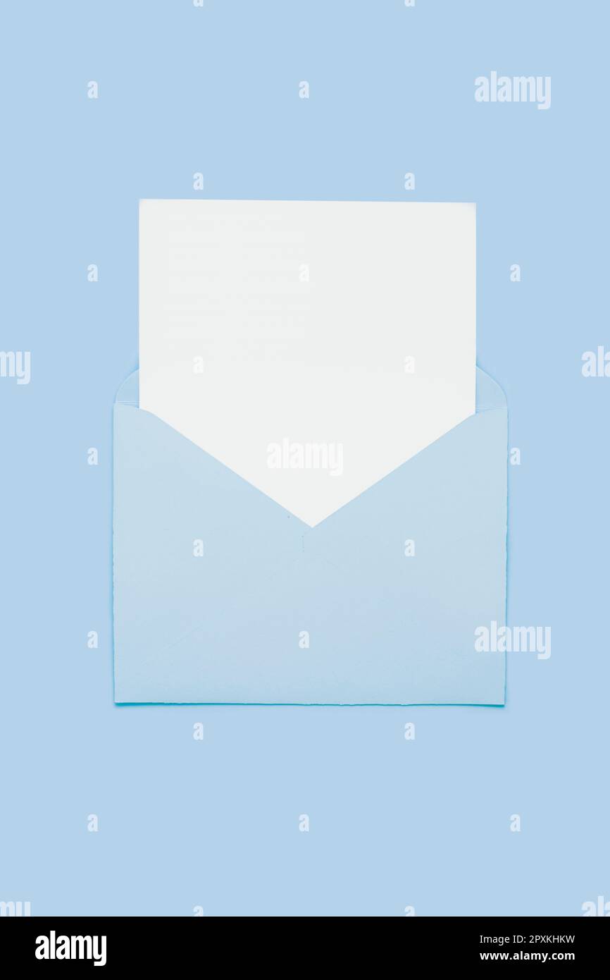 Empty Envelope Card Closeup on blank empty white paper card in blue opened envelope ...