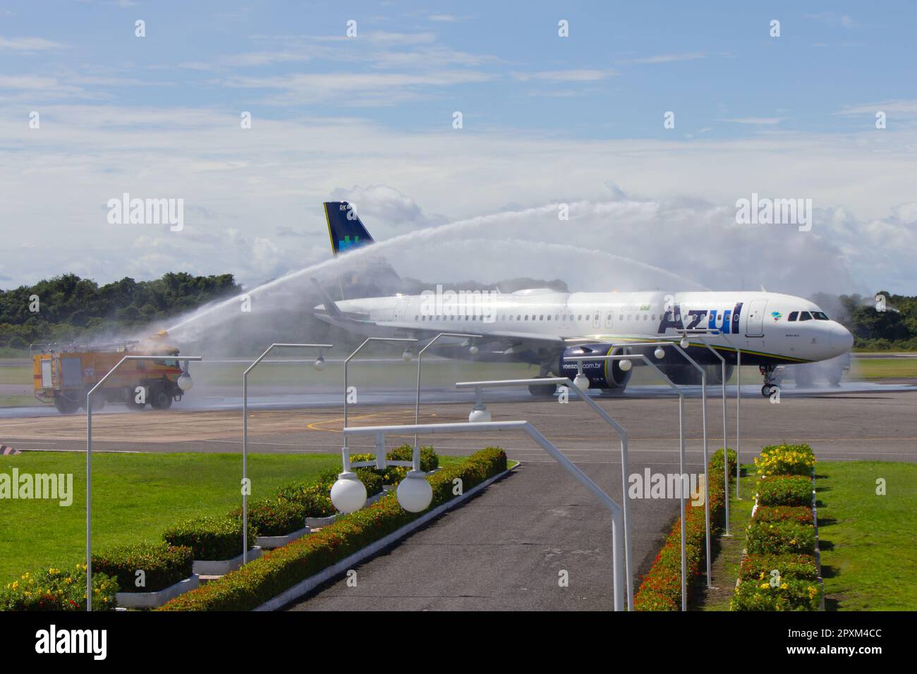Firefighter trucks perform water salutes to Airbus A320 Neo - PR-YRK - from Azul Brazilian Airlines on their first landing at Santarem Airport. Stock Photo
