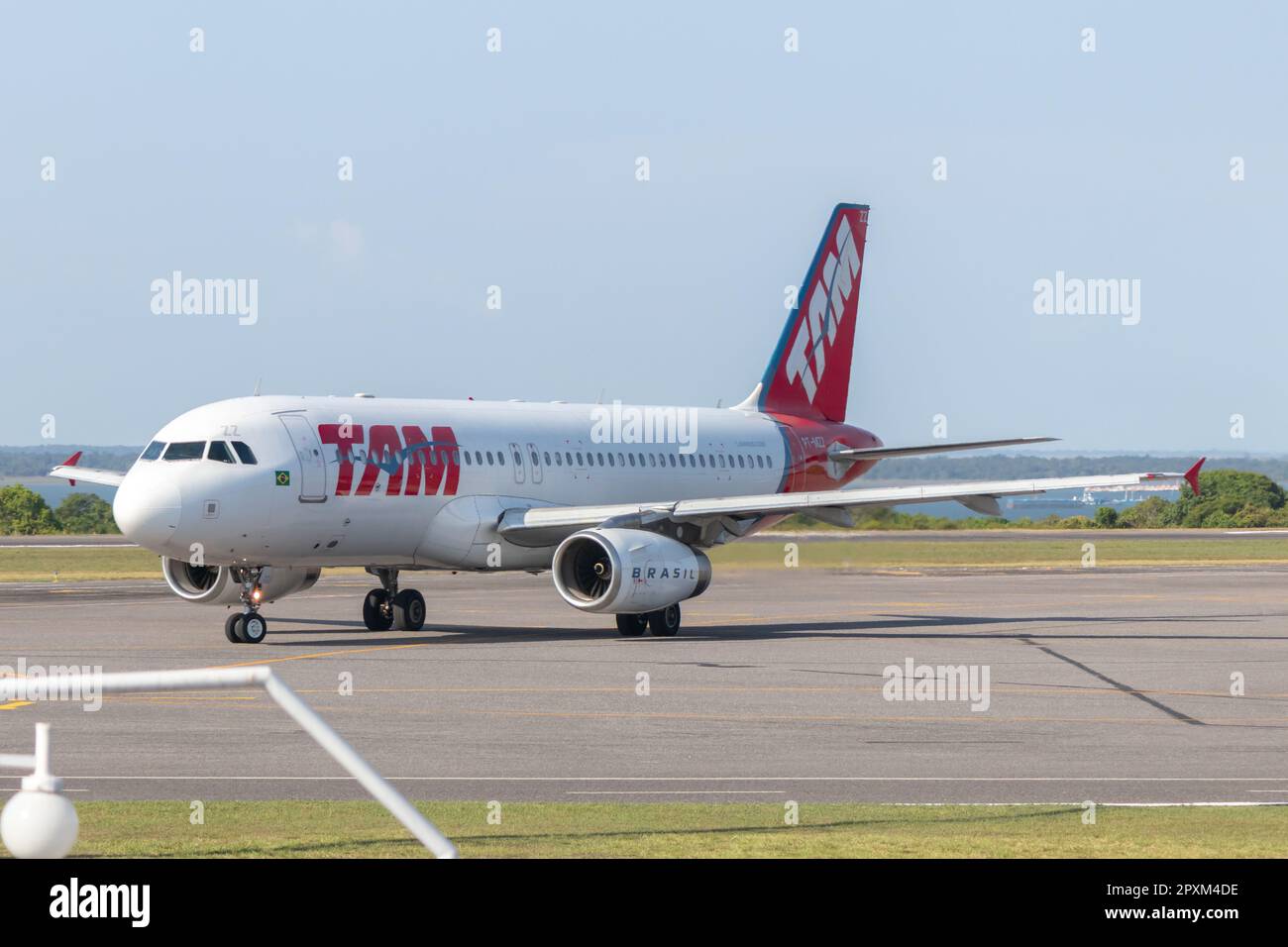 LATAM plane, still painted by TAM, taxiing through the taxiway at Santarem Airport. An Airbus A320, registration PT-MZZ Stock Photo