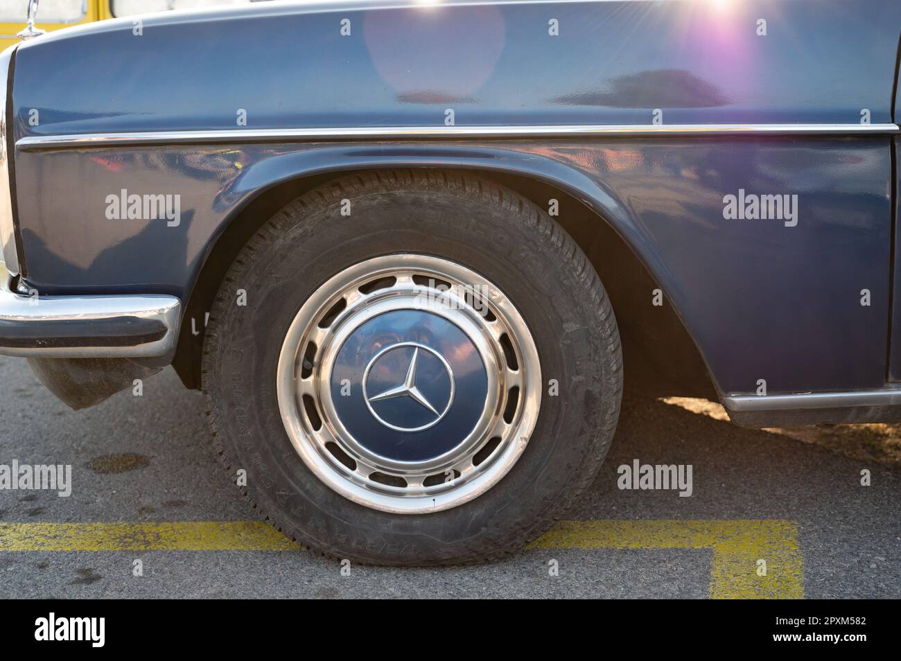 Detail of the wheel of a German luxury classic, it is a blue Mercedes Benz W115 W114 Stock Photo