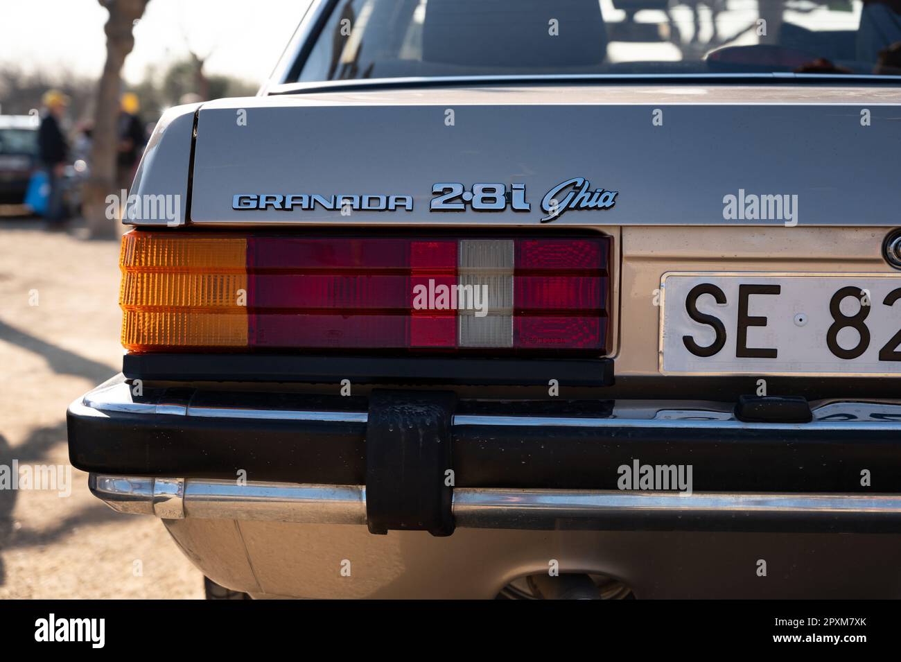 Detail of the rear of a gold colored Ford Granada, badage
