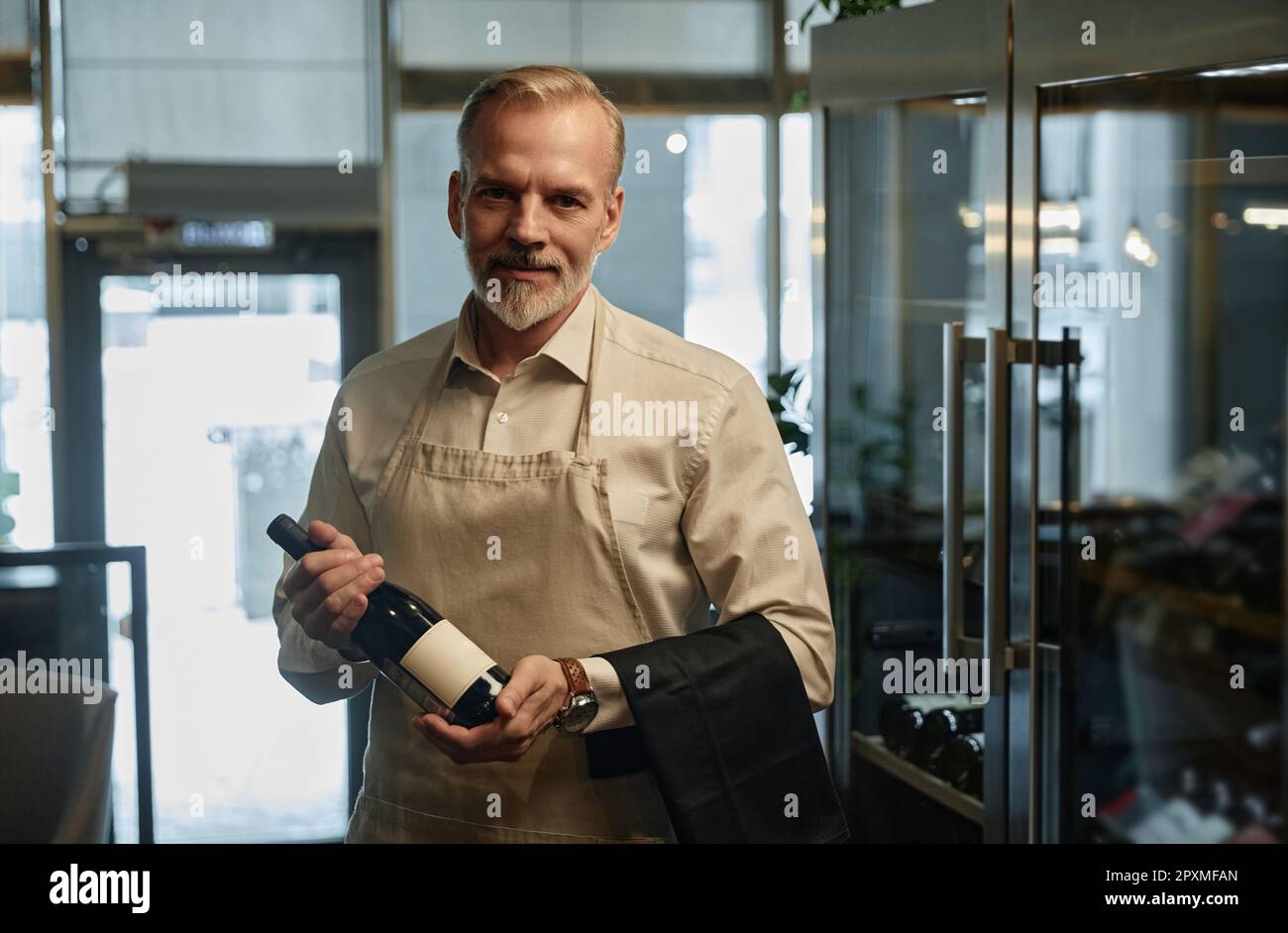 Waiter holding bottle hi-res stock photography and images - Alamy