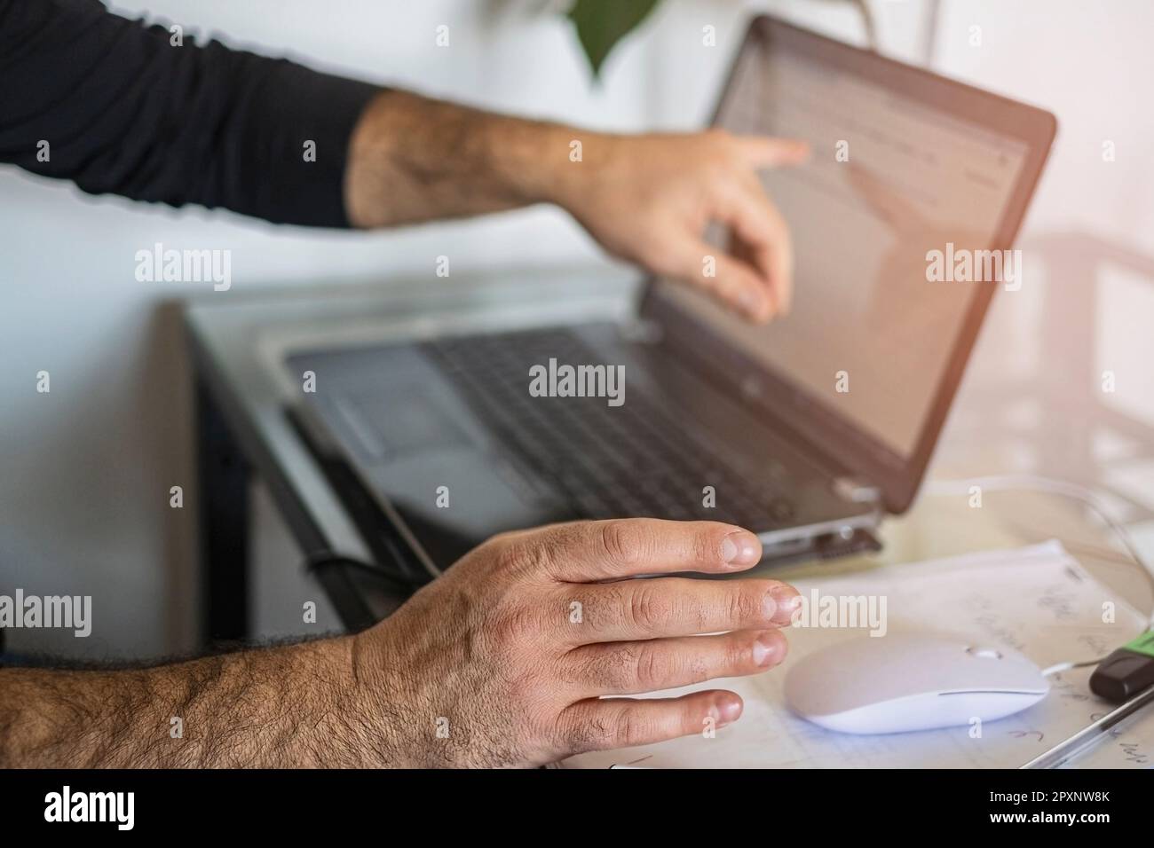 A man's using laptop hand on mouse and shows the screen Stock Photo - Alamy