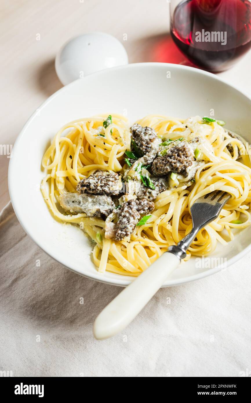 Linguine pasta with morel mushrooms, cheese, cream sauce and wine Stock