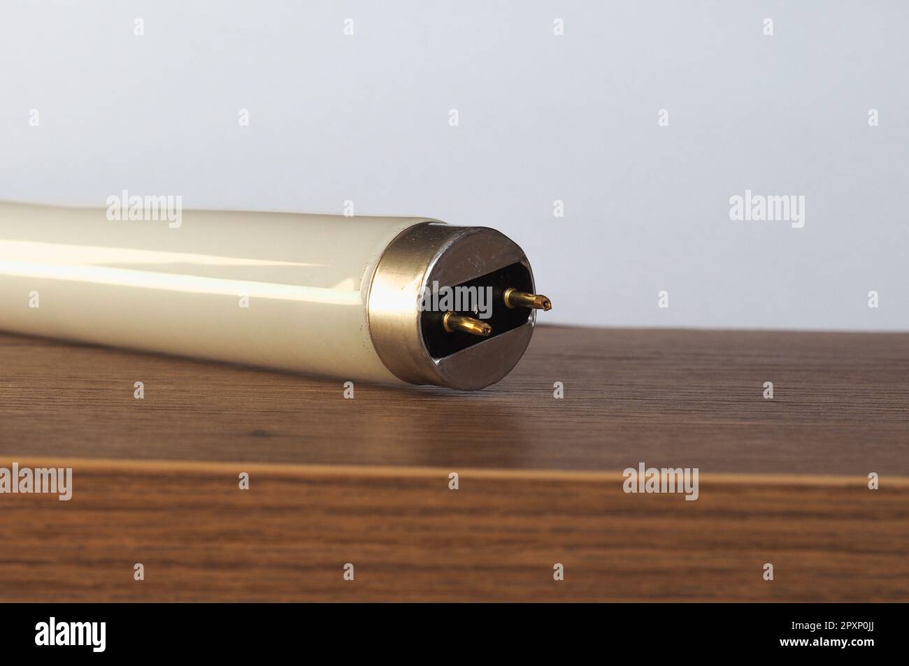 fluorescent tube light bulb over wooden desktop Stock Photo Alamy