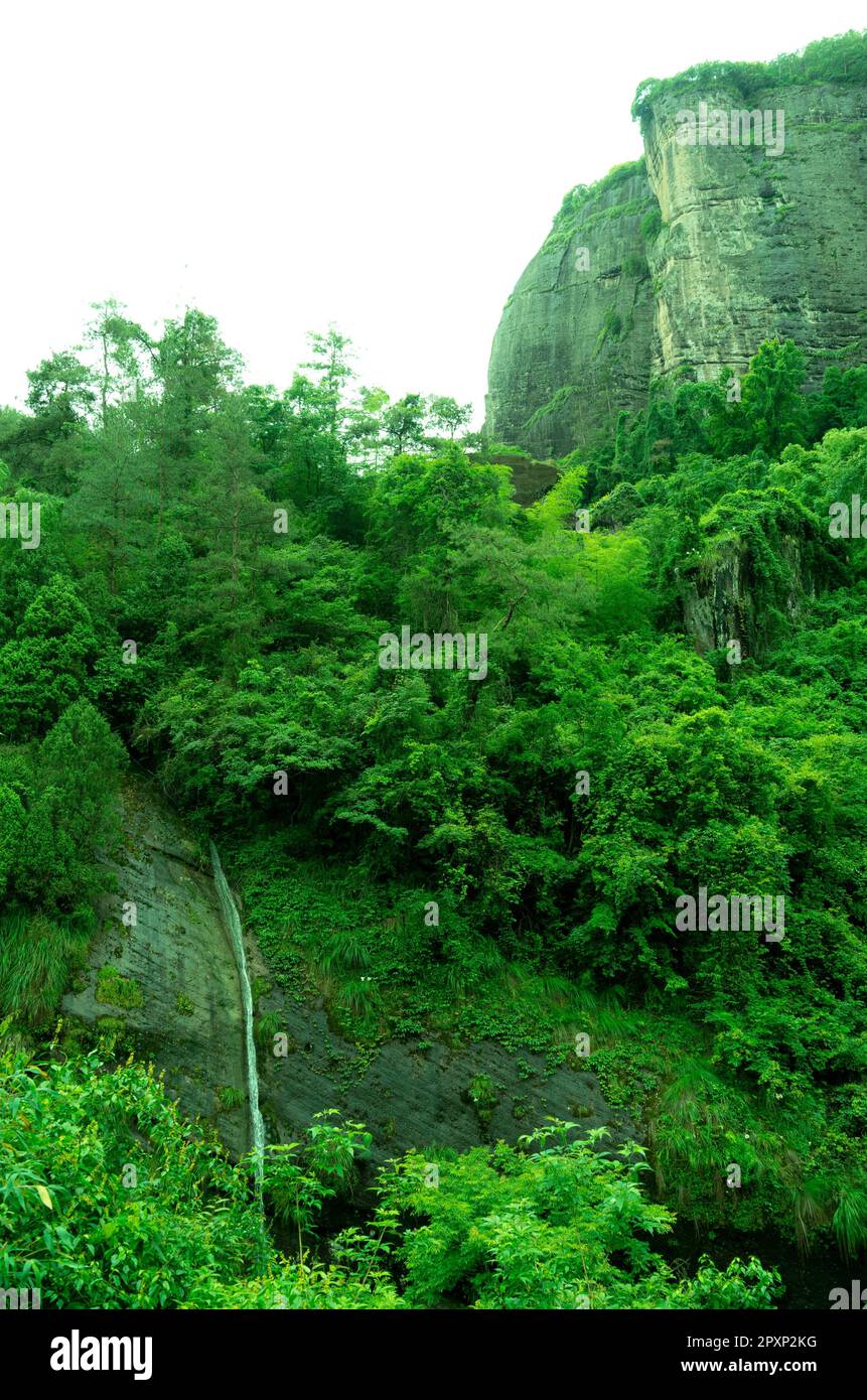 A majestic waterfall cascading down the side of a towering mountain ...