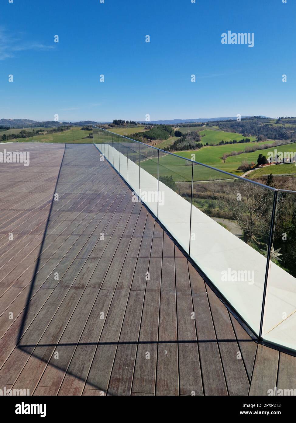 This stunning image features a glass railing with a beautiful view out ...