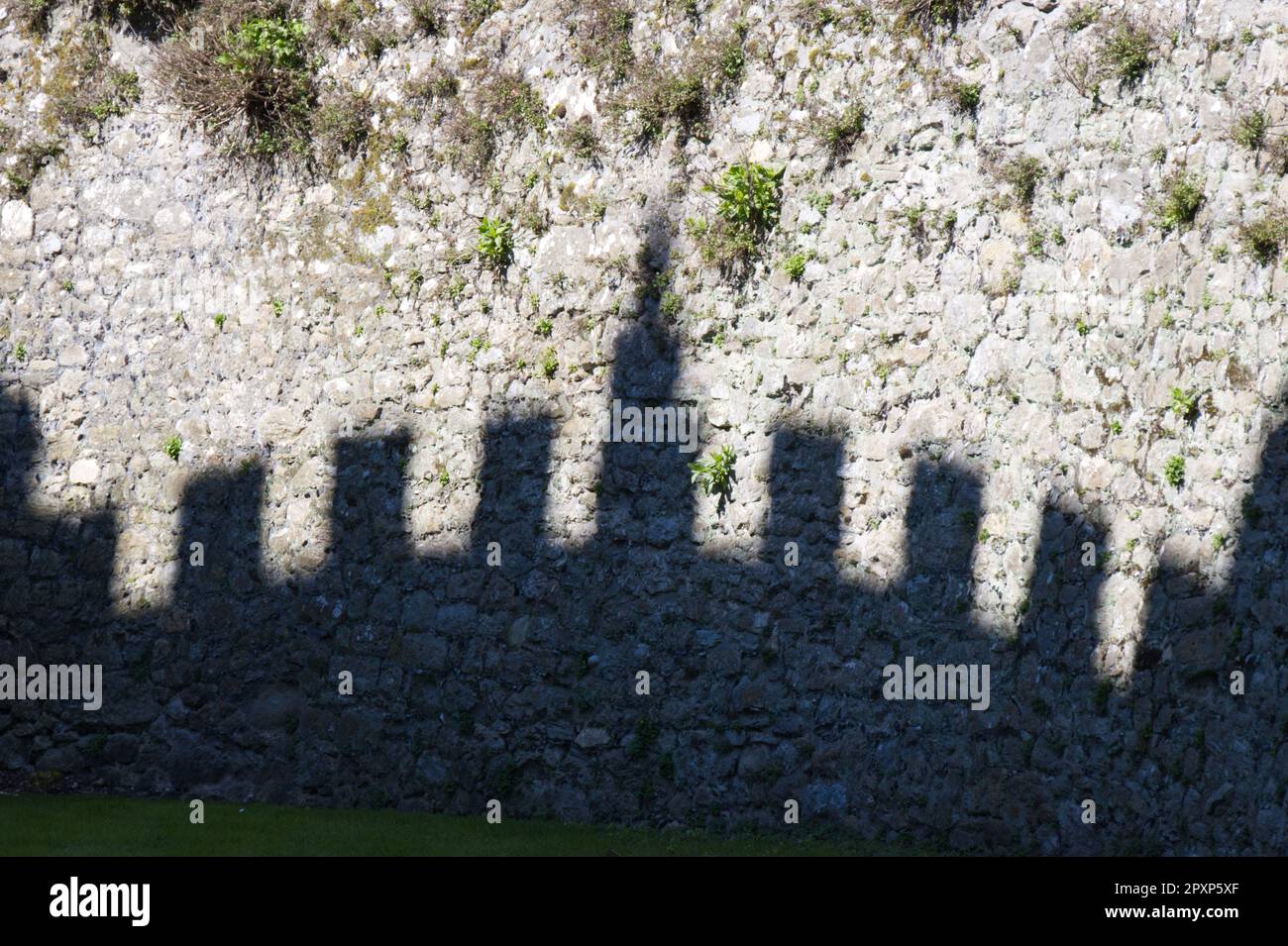 The shadow of English Heritage owned, Walmer Castle against the moat wall.  Deal, Kent UK in April Stock Photo