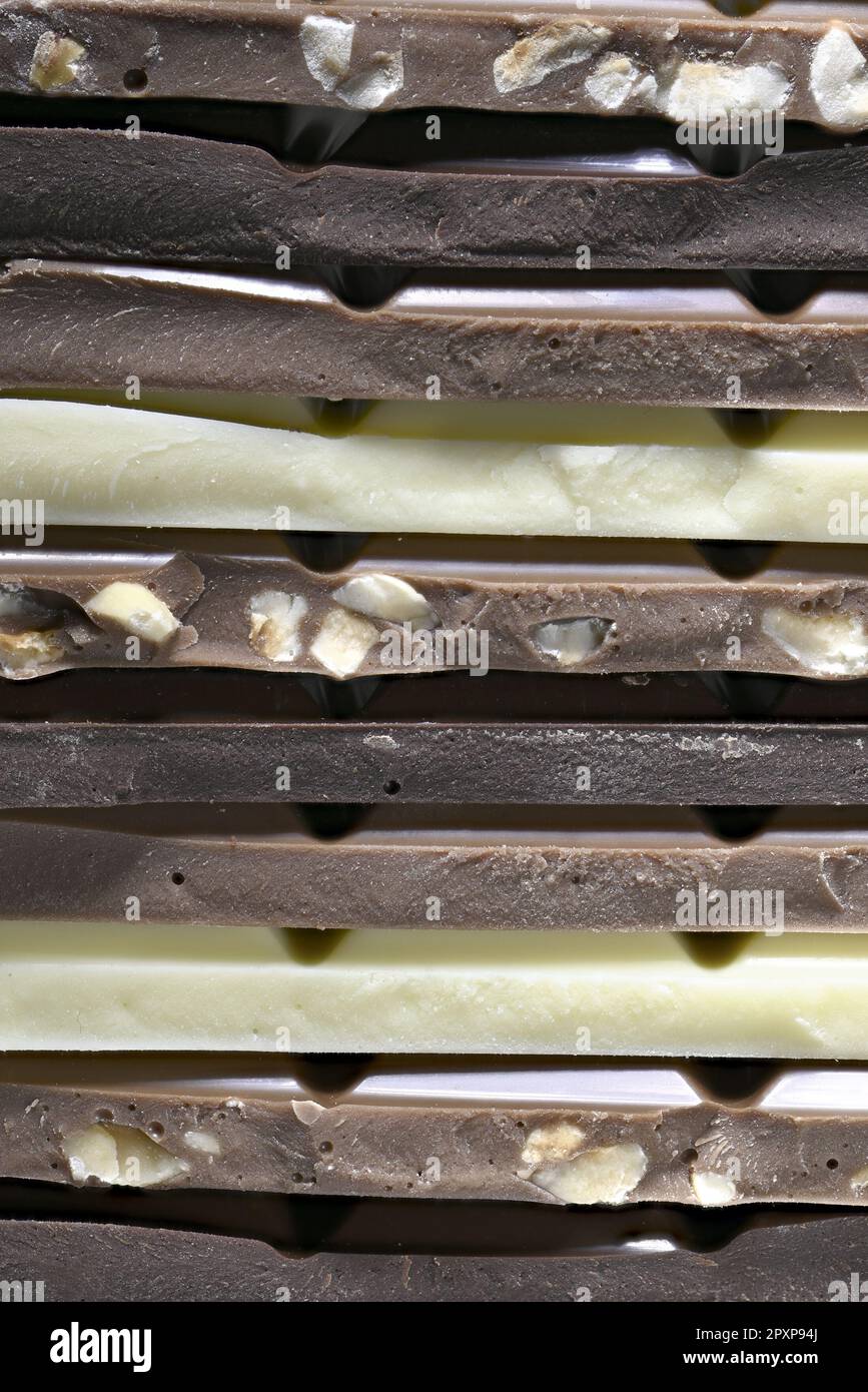 Dark, milk, hazelnut and white chocolate in a stack Stock Photo