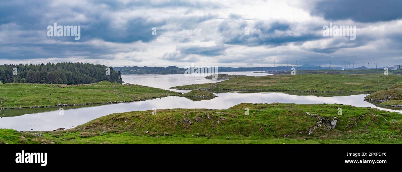 Panorama of the beautiful landscape of the island of Karmoy in Rogaland, Norway, with dark cloudy sky Stock Photo