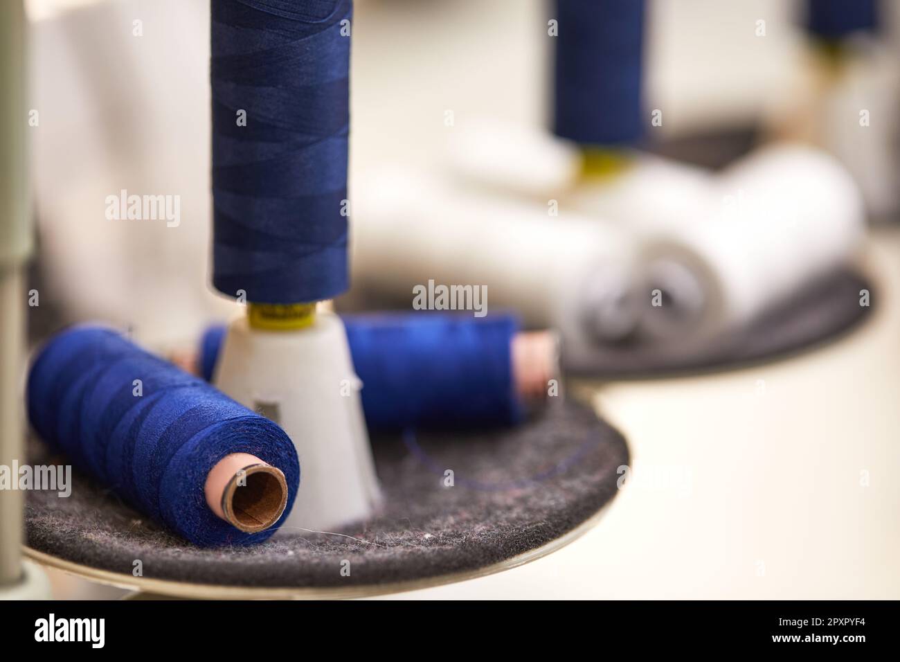 cotton thread rolls for sewing machine. blue and white thread spools ...