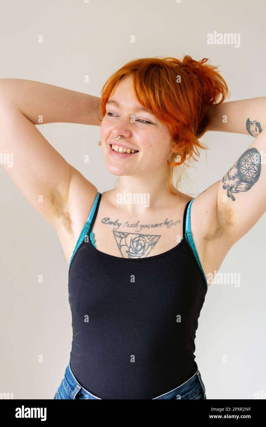 A Beautiful Woman In Her Mid Twenties With Tattoos And Unshaved Armpits