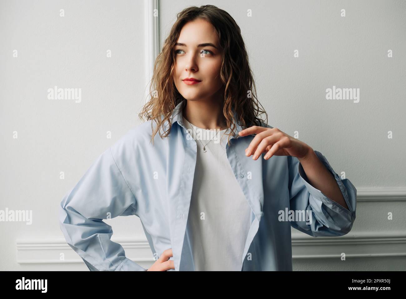 Standing woman in blue shirt hi-res stock photography and images - Alamy