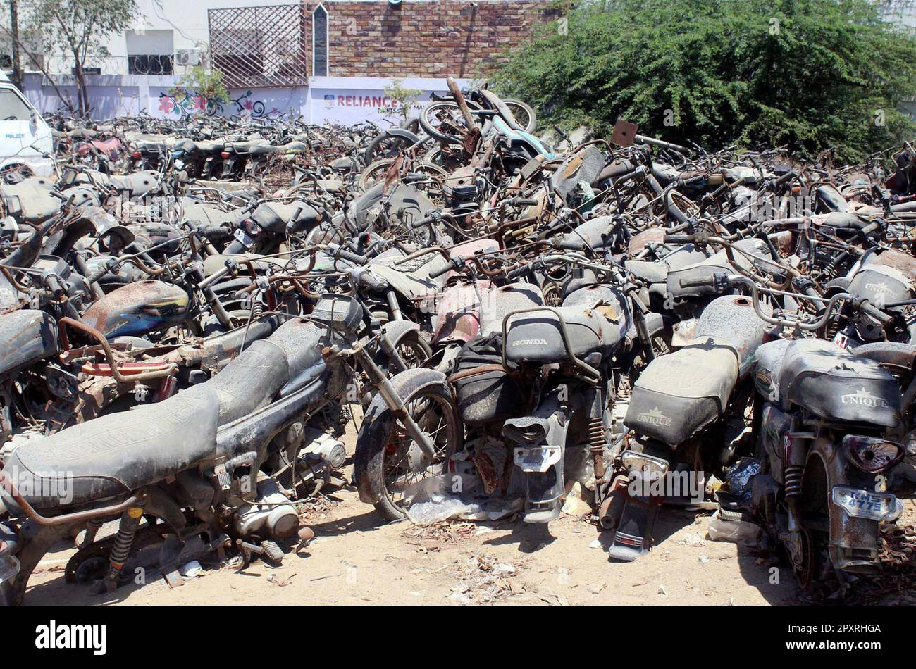 Impounded vehicles are ruining outside Defence Police Station, showing the negligence of concerned authorities, in Karachi on Tuesday, May 2, 2023. According to rules impounded vehicles must be auction by government every year but from 1992 Government did not auction any vehicle. Stock Photo