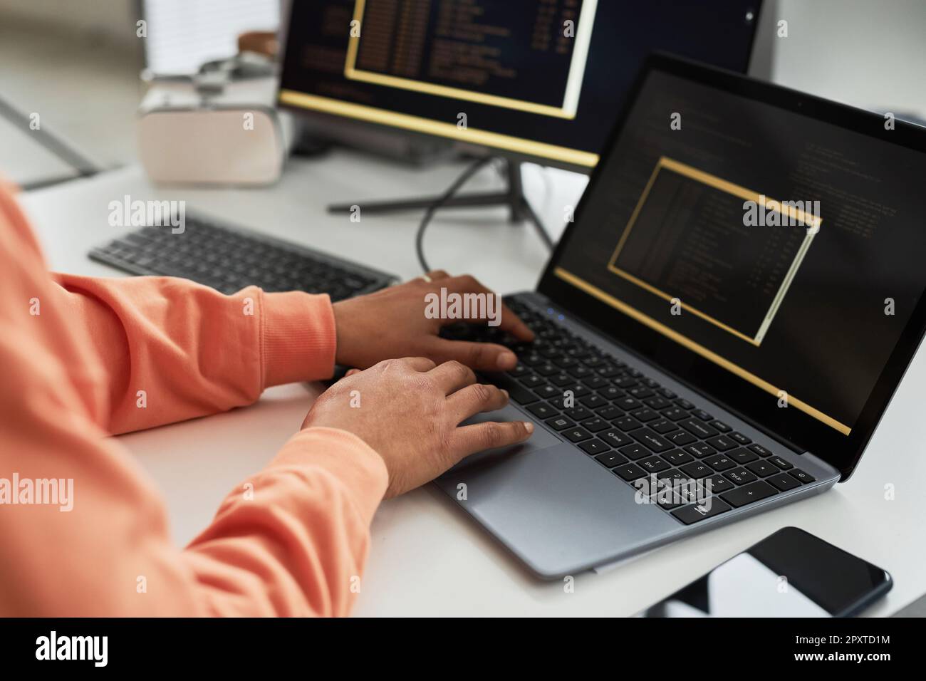 Close-up of programmer writing code for on laptop for software while working at workplace in office Stock Photo