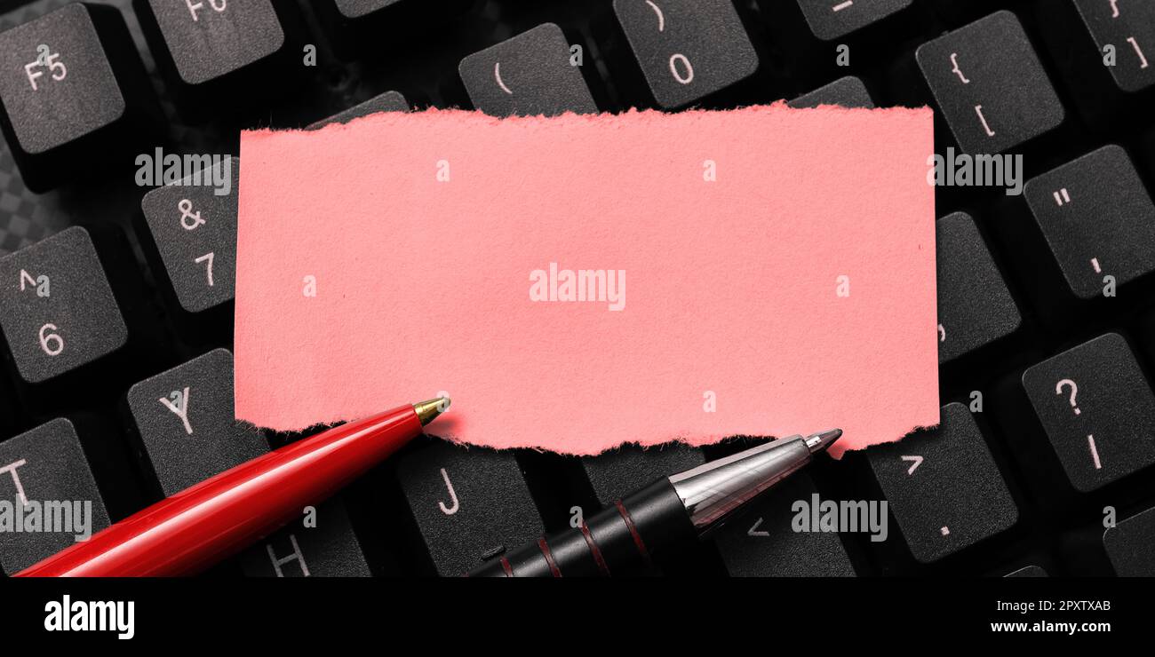 Sticker lying on black keyboard. Important message written over paper ...