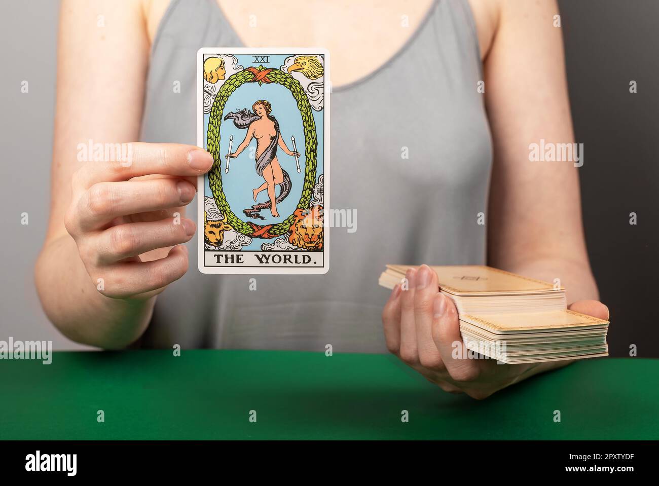 Lodz Poland April 15 2023 The World, major arcana, hand holding showing tarot card during divination. Stock Photo