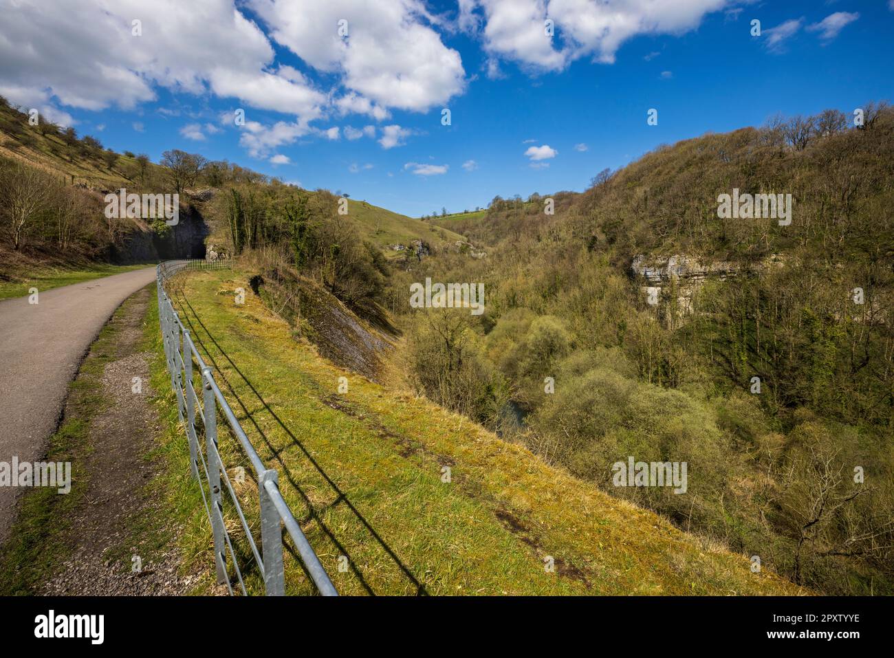 Approaching the Litton Tunnel on the Monsal Trail at Cressbrook with the river Wye below, Derbyshire, England Stock Photo
