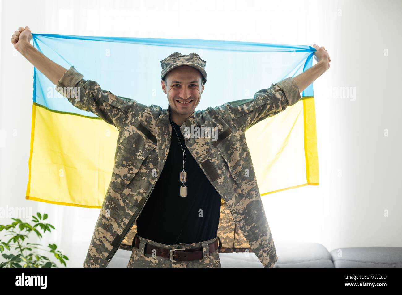 Ukrainian man warrior dressed in a military pixel uniform holds the ...