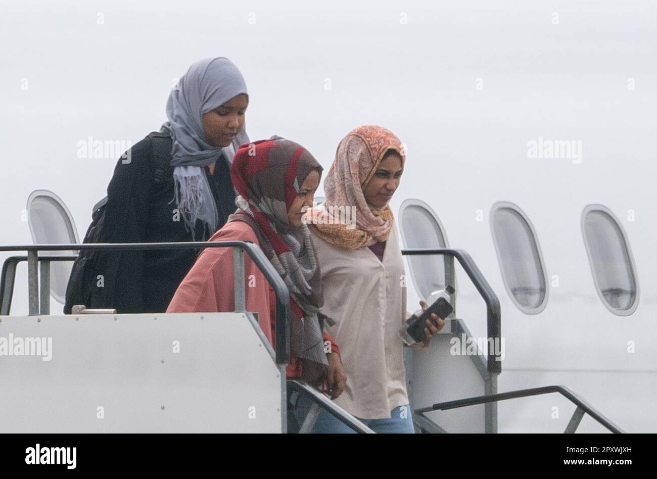 People evacuated from sudan arrive on a flight from cyprus into