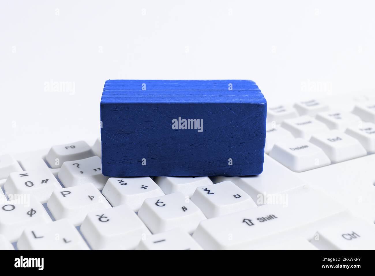 Colored cube with important message lying on keyboard. Main information. Stock Photo